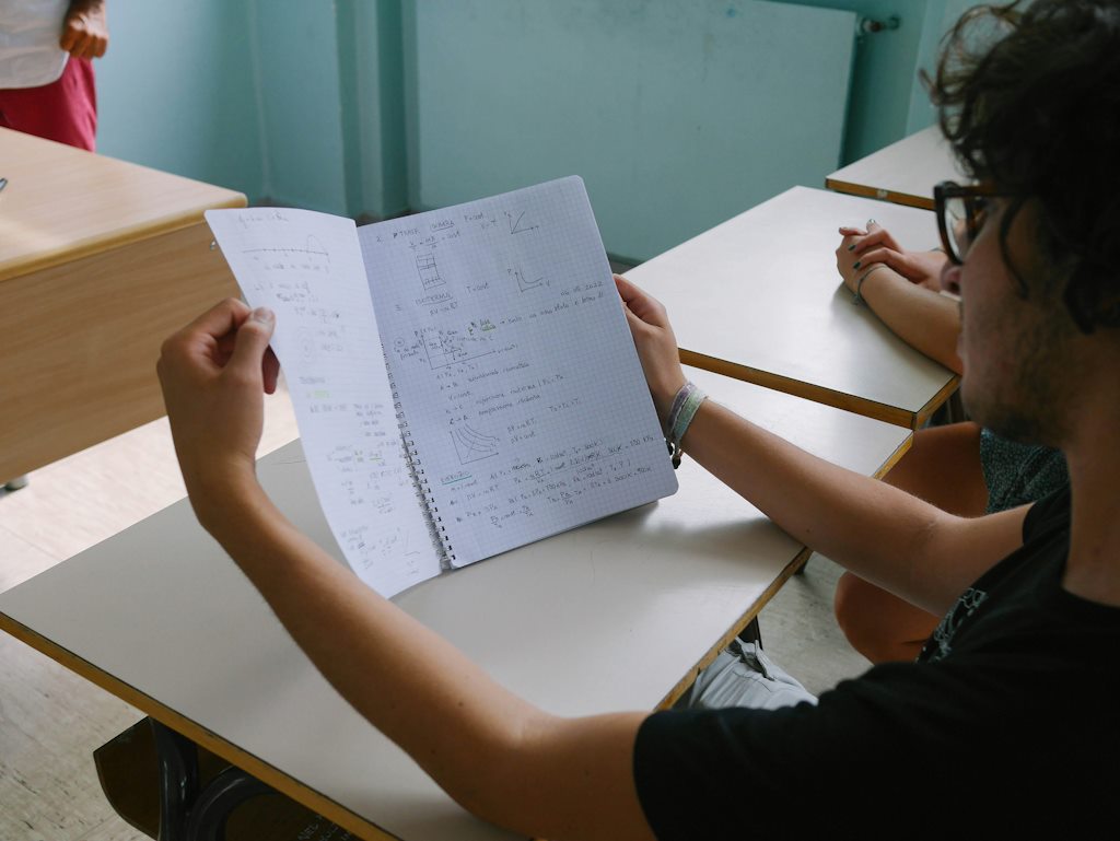 Un élève tient ses cours de maths ouverts en classe.